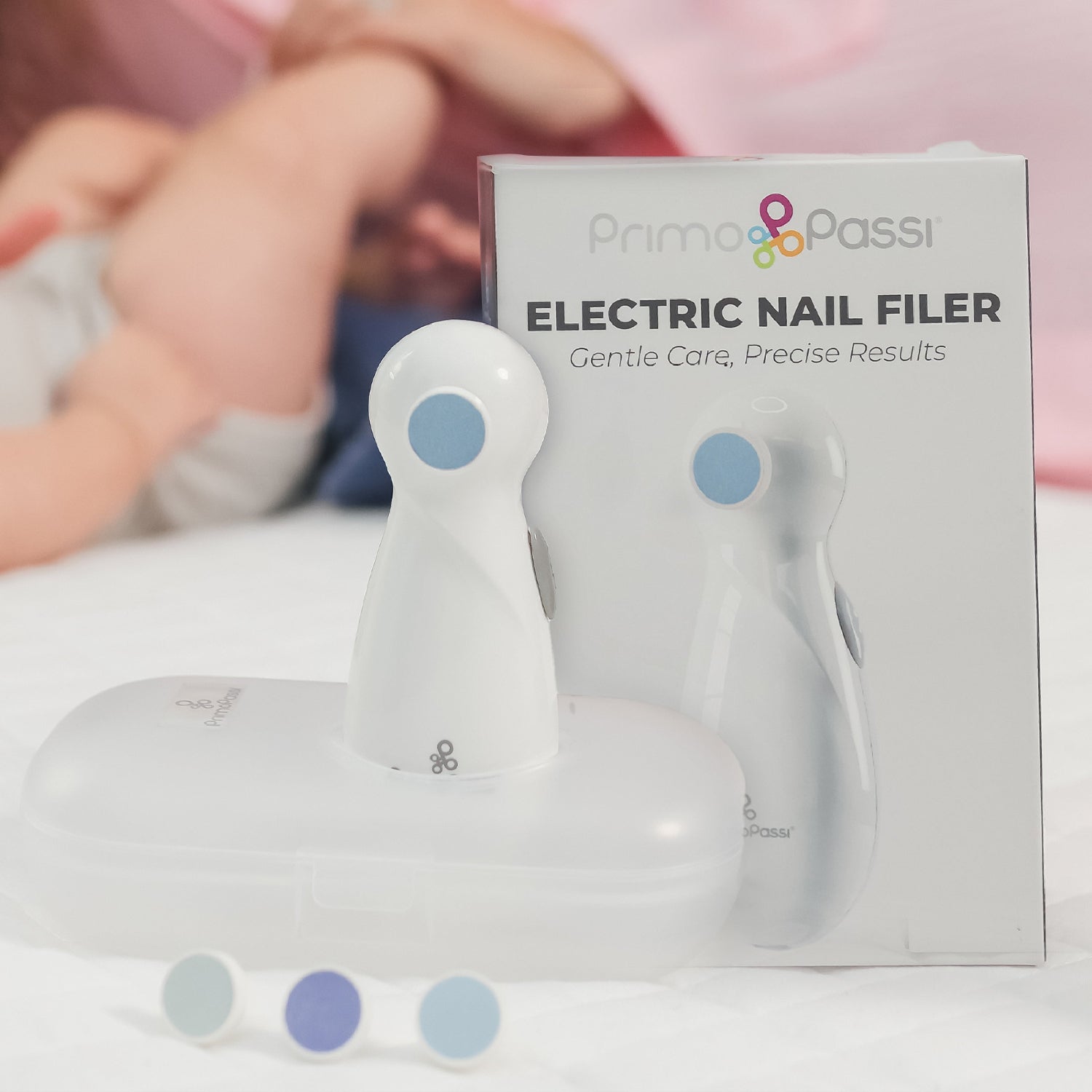 A white electric nail filer with its box and extra pads