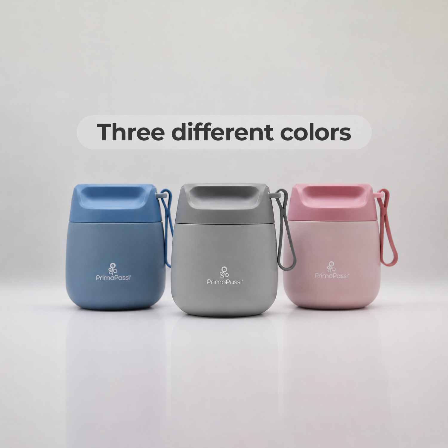 Three insulated food jars in blue, gray, and pink on a white background