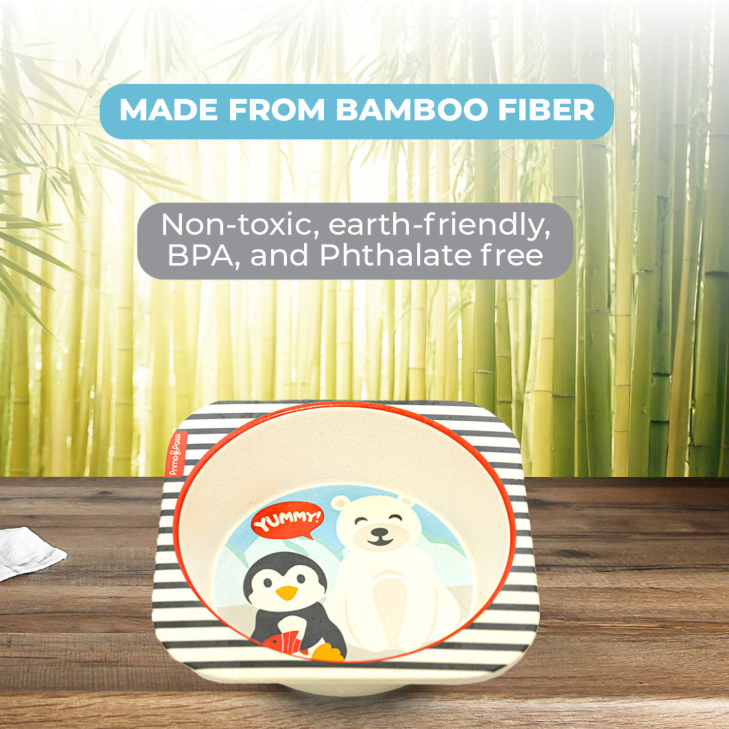 Square bamboo fiber children's bowl featuring a playful arctic-themed design with a smiling polar bear and a penguin holding a fish. The image highlights that the bowl is made from non-toxic, eco-friendly bamboo fiber and is BPA- and phthalate-free.