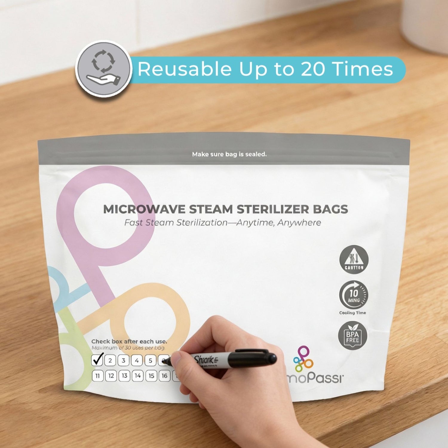 Microwave steam sterilizer bags packaging with a hand holding a marker on a wooden surface