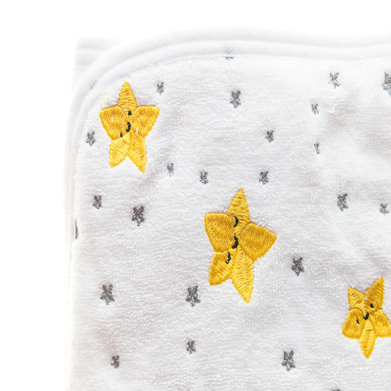 Close-up of a white hooded baby towel featuring embroidered yellow stars and a soft plush texture. Made with absorbent, gentle fabric, this cozy towel helps keep babies warm and dry after bath time.