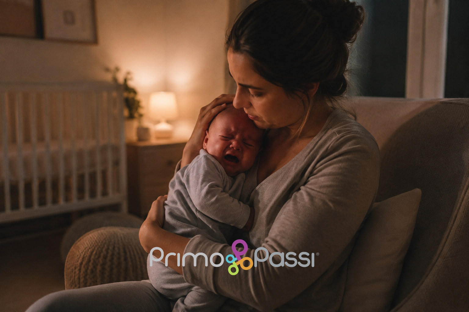 Mother comforting a crying baby in a nursery.
