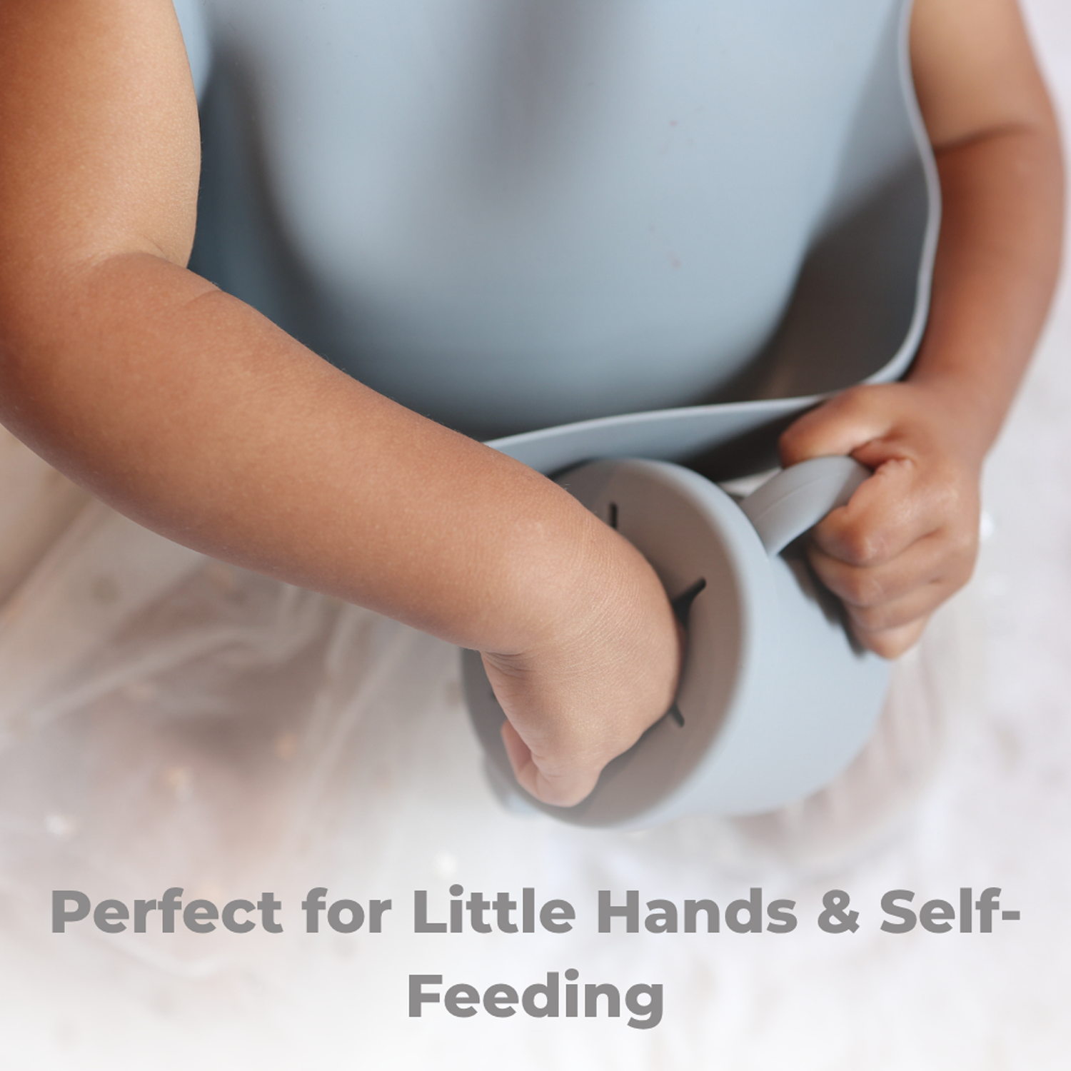 Child holding a spoon with text 'Perfect for Little Hands & Self-Feeding' on a light background