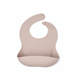 Silicone bib in a soft pink color on a white background