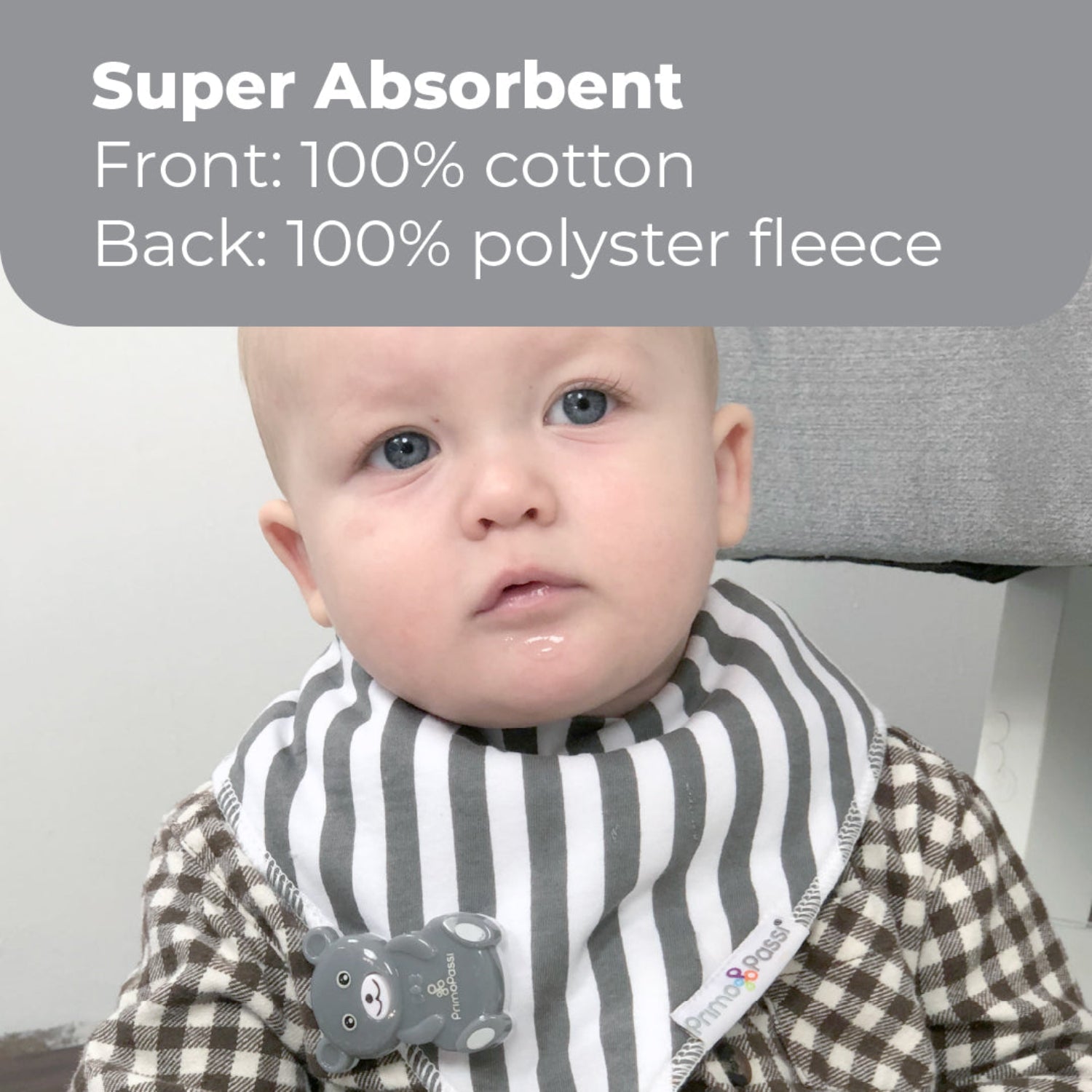 Baby wearing a Primo Passi gray-and-white striped bandana bib made with a 100% cotton front and soft polyester fleece backing. The super absorbent bib helps keep clothing dry during feeding, drooling, and teething.