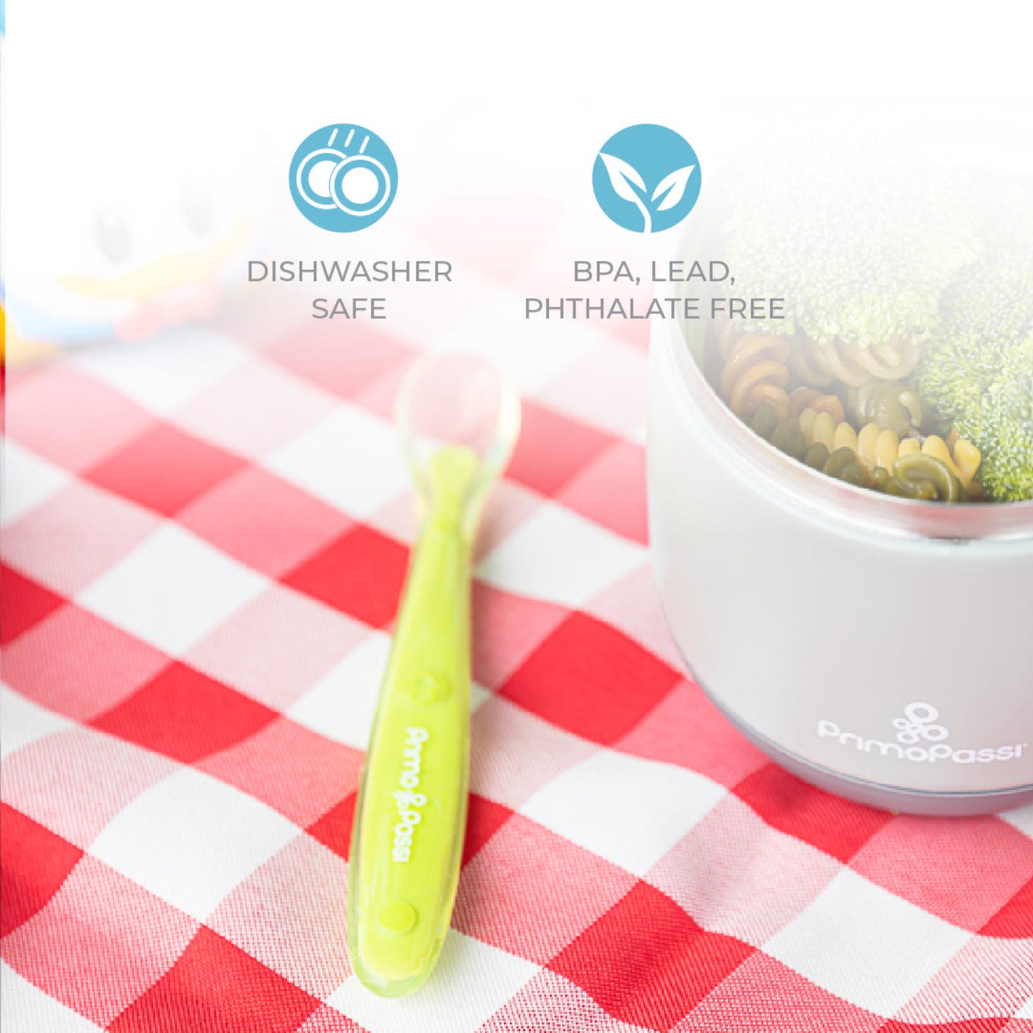 Green spoon and grey container on a red and white checkered tablecloth with 'Dishwasher Safe' and 'BPA, Lead, Phthalate Free' icons.
