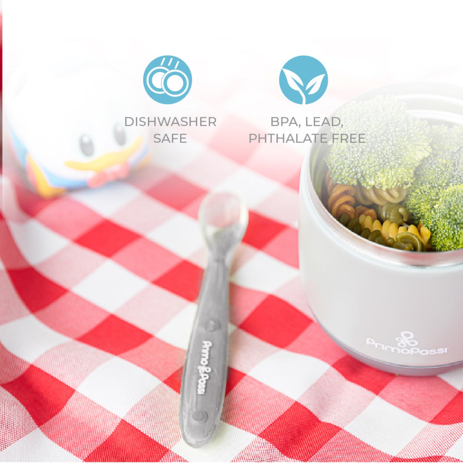 Gray Primo Passi silicone baby spoon placed beside an insulated food jar filled with pasta and broccoli. Made from food-grade silicone, the spoon is dishwasher safe, BPA-, lead-, and phthalate-free, making it a safe choice for everyday baby feeding.