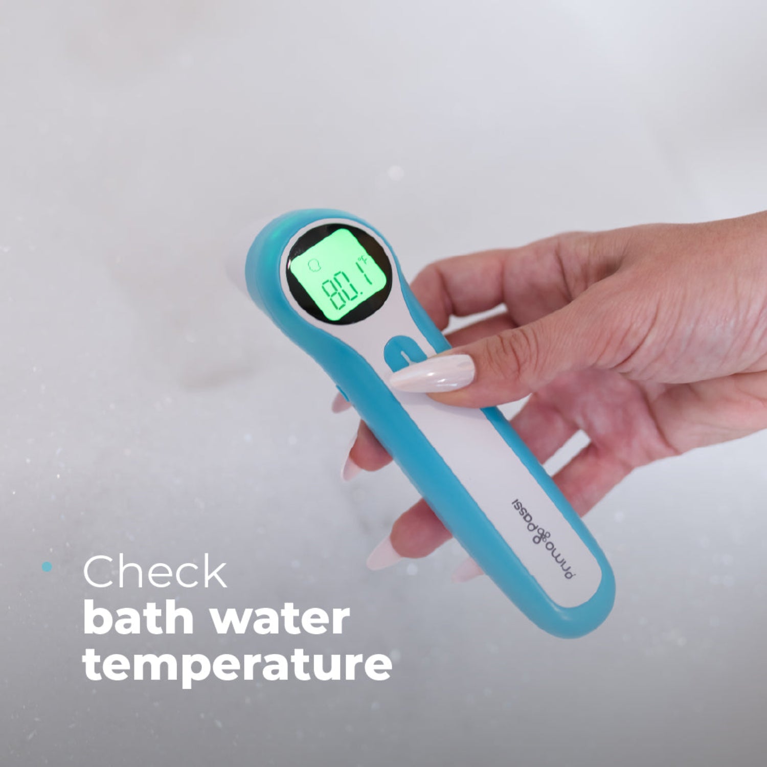 A hand holding a blue and white digital bath thermometer with a green LCD screen showing 80.1.